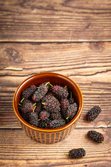 Ripe fresh blackberry fruits on the table.