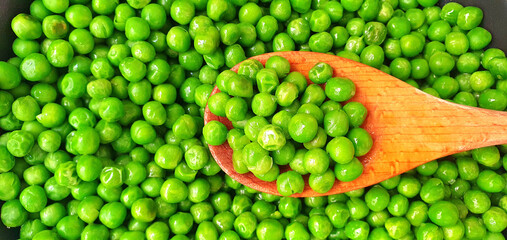 Cooking green peas. Dish with stewed green peas. Delicious healthy green peas. Healthy legumes.