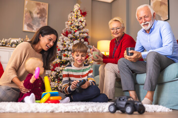 Children spending Christmas day at home with mother and grandparents