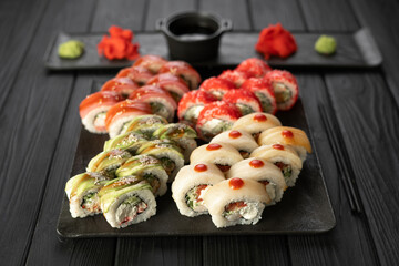 Sushi set. Philadelphia roll, california with fresh ingredients on black background. Sushi menu. Japanese food concept.
