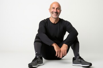 portrait of a confident Israeli man in his 40s wearing a pair of leggings or tights against a white background