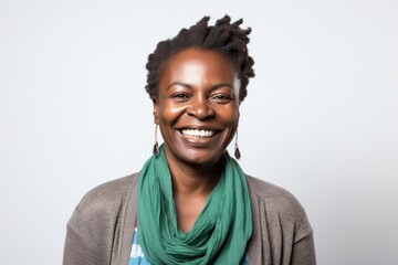 Obraz premium portrait of a confident Kenyan woman in her 40s wearing a chic cardigan against a white background