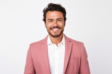 portrait of a confident Mexican man in his 30s wearing a chic cardigan against a white background