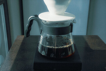 Dark coffee elixir flows from the V-60 dripper into glass decanter