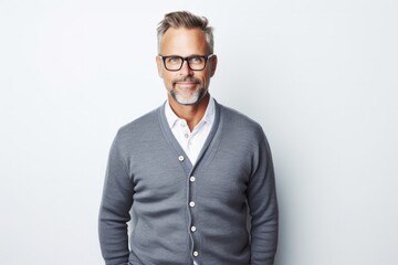portrait of a confident Polish man in his 40s wearing a chic cardigan against a white background