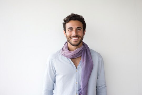 Portrait of a Israeli man in his 20s wearing a foulard against a minimalist or empty room background