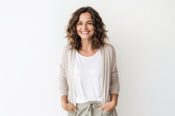 Portrait of a Israeli woman in her 30s wearing a chic cardigan against a white background