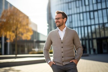 Portrait of a Polish man in his 30s wearing a chic cardigan against a modern architectural background