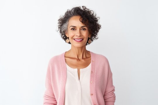 Portrait Of A Mexican Woman In Her 60s Wearing A Chic Cardigan Against A White Background