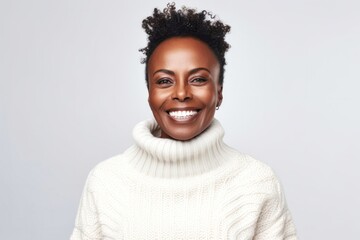Obraz premium medium shot portrait of a confident Kenyan woman in her 40s wearing a cozy sweater against a white background