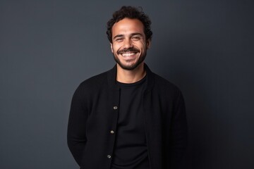 Obraz premium medium shot portrait of a confident Mexican man in his 20s wearing a chic cardigan against a minimalist or empty room background