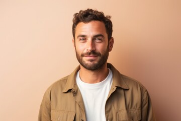 Obraz premium Portrait of a confident Israeli man in his 30s wearing a chic cardigan against a pastel or soft colors background