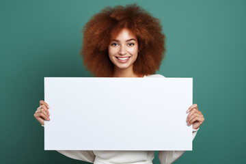 Beautiful woman holding a blank billboard on green background