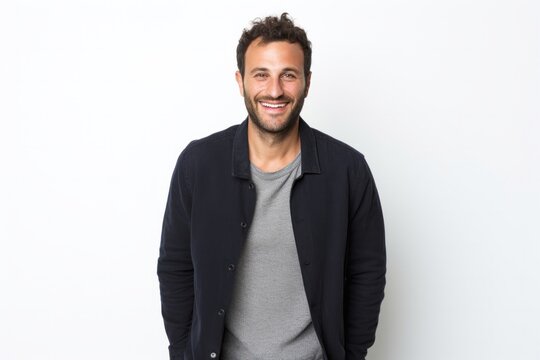 Portrait of a confident Israeli man in his 30s wearing a chic cardigan against a white background