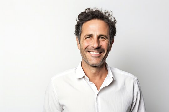 Portrait of a confident Israeli man in his 40s wearing a chic cardigan against a white background