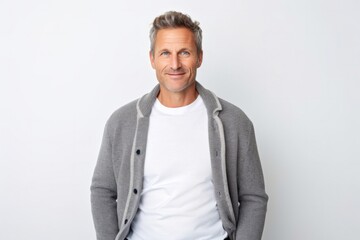 Fototapeta premium Portrait of a confident Polish man in his 40s wearing a chic cardigan against a white background