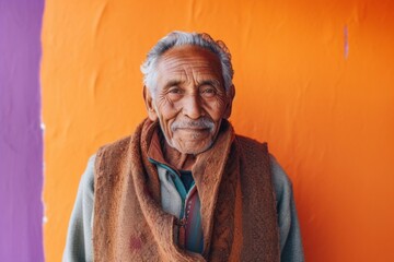 medium shot portrait of a 100-year-old elderly Mexican man wearing a chic cardigan against an abstract background
