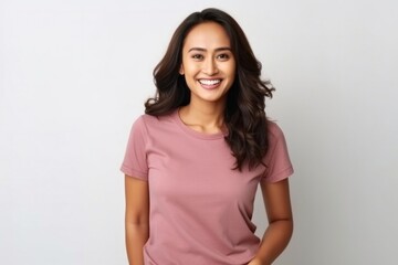 Fototapeta premium medium shot portrait of a happy Filipino woman in her 30s wearing a casual t-shirt against a white background