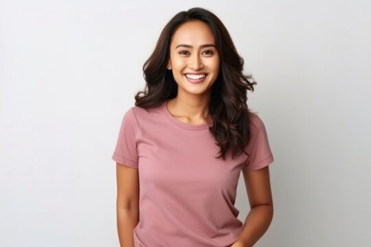 medium shot portrait of a happy Filipino woman in her 30s wearing a casual t-shirt against a white background