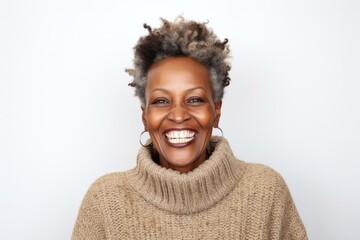 medium shot portrait of a happy Kenyan woman in her 50s wearing a cozy sweater against a white background