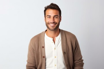 medium shot portrait of a happy Israeli man in his 30s wearing a chic cardigan against a white background