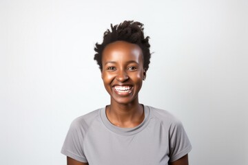 medium shot portrait of a happy Kenyan woman in her 30s wearing knee-length shorts against a white background - obrazy, fototapety, plakaty