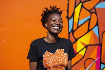 medium shot portrait of a happy Kenyan woman in her 30s wearing a fun graphic tee against an abstract background