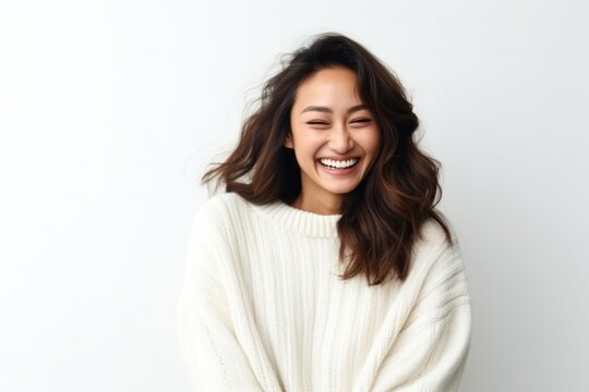medium shot portrait of a Filipino woman in her 30s wearing a cozy sweater against a white background
