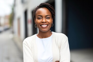 medium shot portrait of a Kenyan woman in her 30s wearing a chic cardigan against a white background