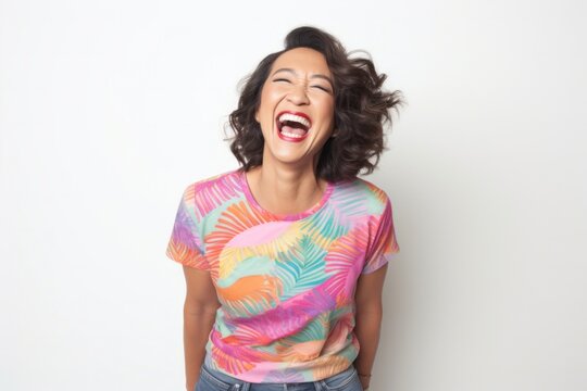 portrait of a Filipino woman in her 40s wearing a fun graphic tee against a white background