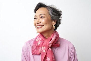 portrait of a Filipino woman in her 50s wearing a foulard against a white background