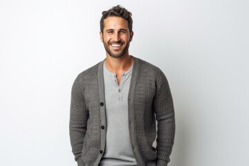 portrait of a Israeli man in his 30s wearing a chic cardigan against a white background