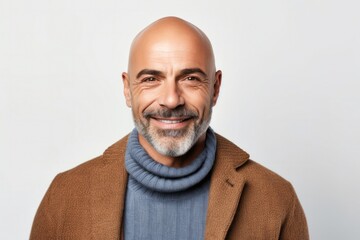 portrait of a Israeli man in his 50s wearing a chic cardigan against a white background