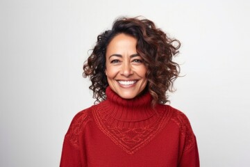 Fototapeta premium medium shot portrait of a Mexican woman in her 40s wearing a cozy sweater against a white background