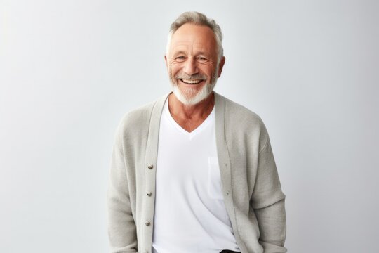 portrait of a Israeli man in his 50s wearing a chic cardigan against a white background