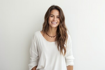 portrait of a Israeli woman in her 30s wearing a simple tunic against a white background
