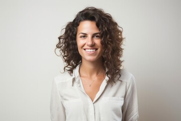 portrait of a Israeli woman in her 30s wearing a simple tunic against a white background