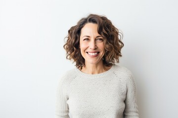 portrait of a Israeli woman in her 40s wearing a cozy sweater against a white background