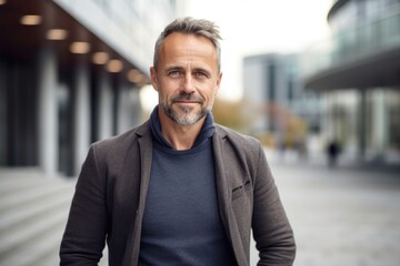 Fototapeta premium medium shot portrait of a Polish man in his 40s wearing a chic cardigan against a modern architectural background