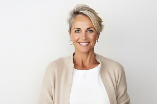 medium shot portrait of a Polish woman in her 40s wearing a chic cardigan against a white background