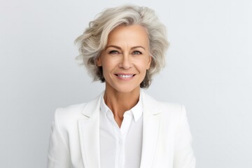 medium shot portrait of a Polish woman in her 50s wearing a classic blazer against a white background - obrazy, fototapety, plakaty