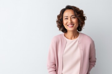 Fototapeta premium medium shot portrait of a confident Filipino woman in her 40s wearing a chic cardigan against a white background