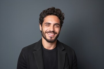 Obraz premium medium shot portrait of a confident Israeli man in his 20s wearing a chic cardigan against a minimalist or empty room background