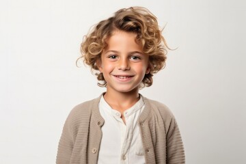 medium shot portrait of a confident Israeli child male wearing a chic cardigan against a white background