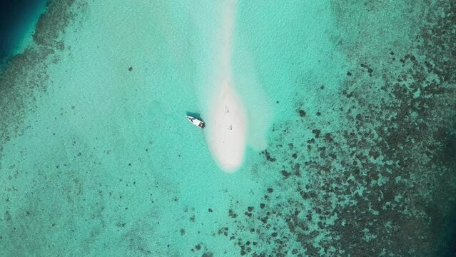 Scenic Aerial Drone View of Sand Bank besides Luxury Boat at Maldives Islands