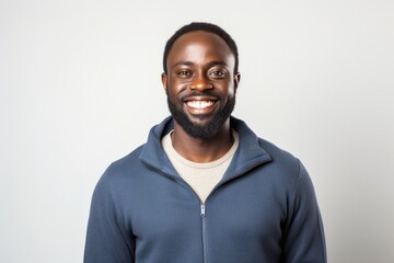 Obraz premium portrait of a Kenyan man in his 30s wearing a chic cardigan against a white background