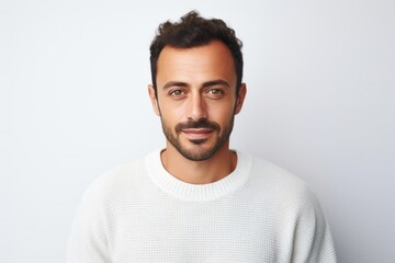 Fototapeta premium medium shot portrait of a confident Israeli man in his 30s wearing a cozy sweater against a white background
