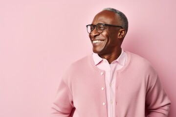 Fototapeta premium portrait of a Kenyan man in his 50s wearing a chic cardigan against a pastel or soft colors background