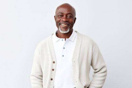 portrait of a Kenyan man in his 50s wearing a chic cardigan against a white background