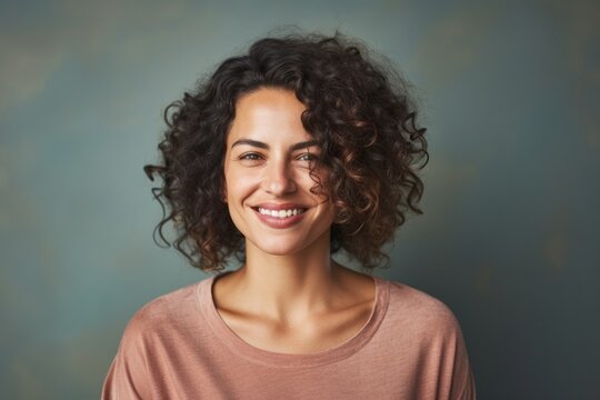 medium shot portrait of a confident Israeli woman in her 30s wearing a cozy sweater against an abstract background